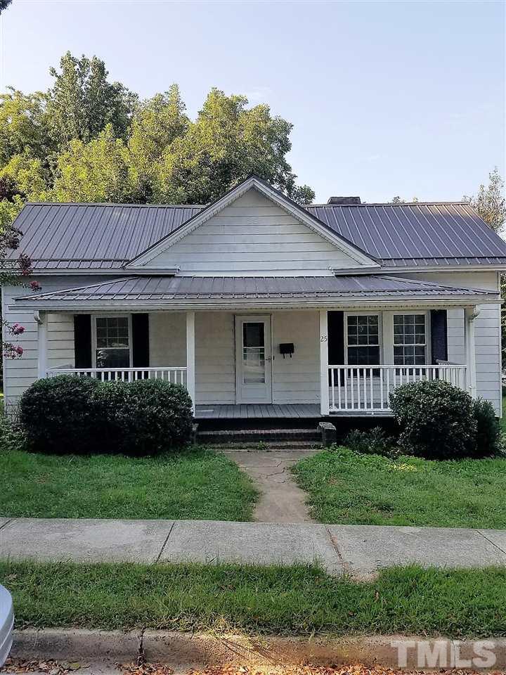25 Oak Street Roxboro, NC 27573 - Photo 1 of 14 a front view of a house with a garden and plants