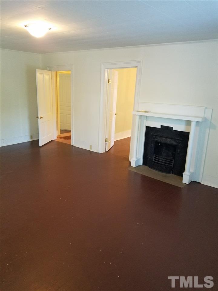 25 Oak Street Roxboro, NC 27573 - Photo 3 of 14 an empty room with windows and fireplace