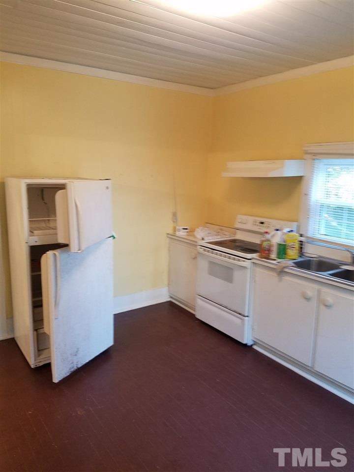 25 Oak Street Roxboro, NC 27573 - Photo 4 of 14 a kitchen with white cabinets and sink