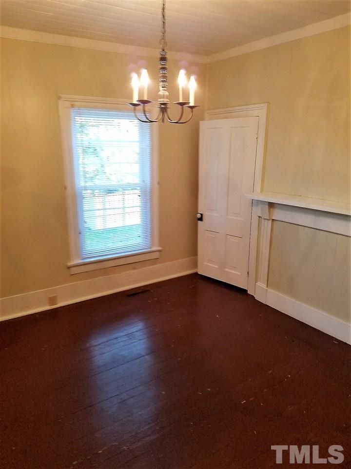 25 Oak Street Roxboro, NC 27573 - Photo 5 of 14 an empty room with wooden floor and windows