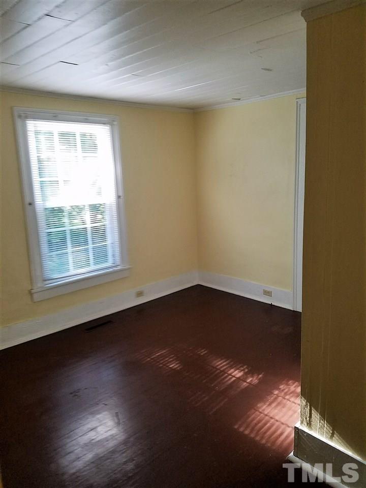 25 Oak Street Roxboro, NC 27573 - Photo 6 of 14 an empty room with wooden floor and windows