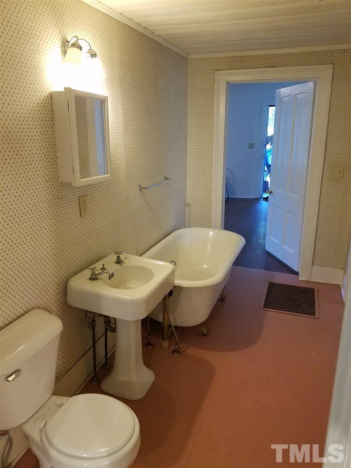 25 Oak Street Roxboro, NC 27573 - Photo 9 of 14 a bathroom with a sink a toilet and mirror