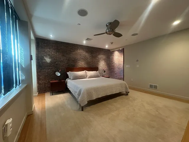 a bedroom with a large bed and a chandelier