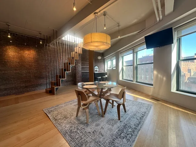 a dining room with furniture and window