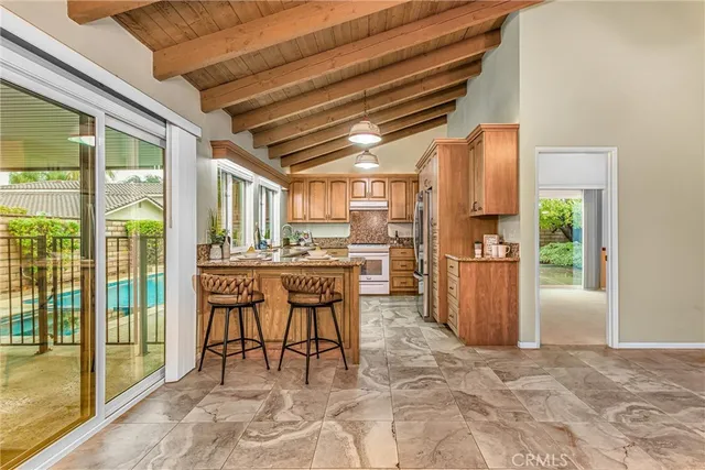 a dining room with furniture and a floor to ceiling window