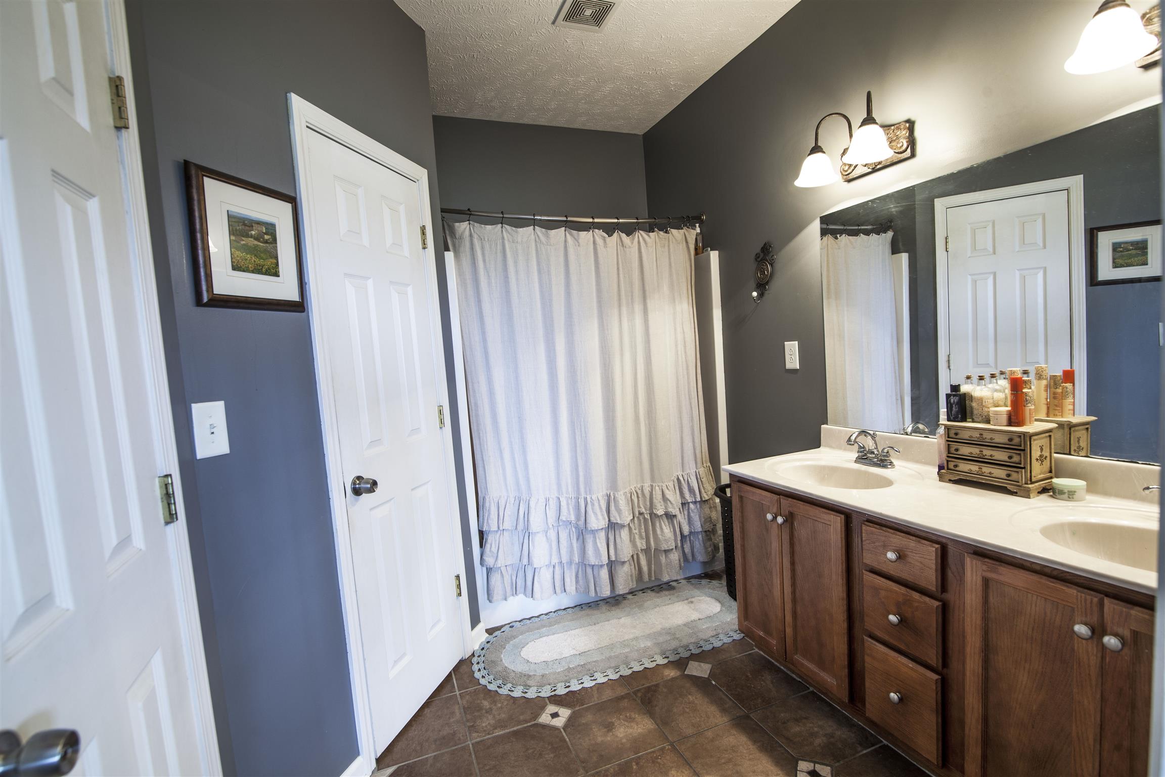 3105 Greens Mill Road Spring Hill, TN 37174 - Photo 9 of 15 a spacious bathroom with a double vanity sink a mirror and a shower