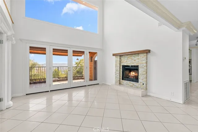 a view of a livingroom with wooden floor and a ceiling fan