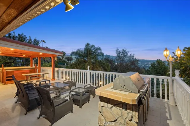 a view of balcony with wooden floor and outdoor seating