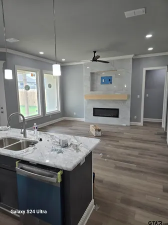 a kitchen with a sink and a mirror