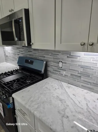 a kitchen with a stove and a microwave