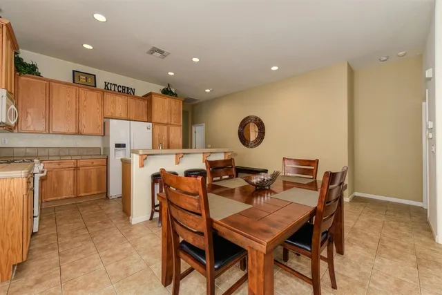 a view of a dining room that has a dining table and chairs with wooden floor