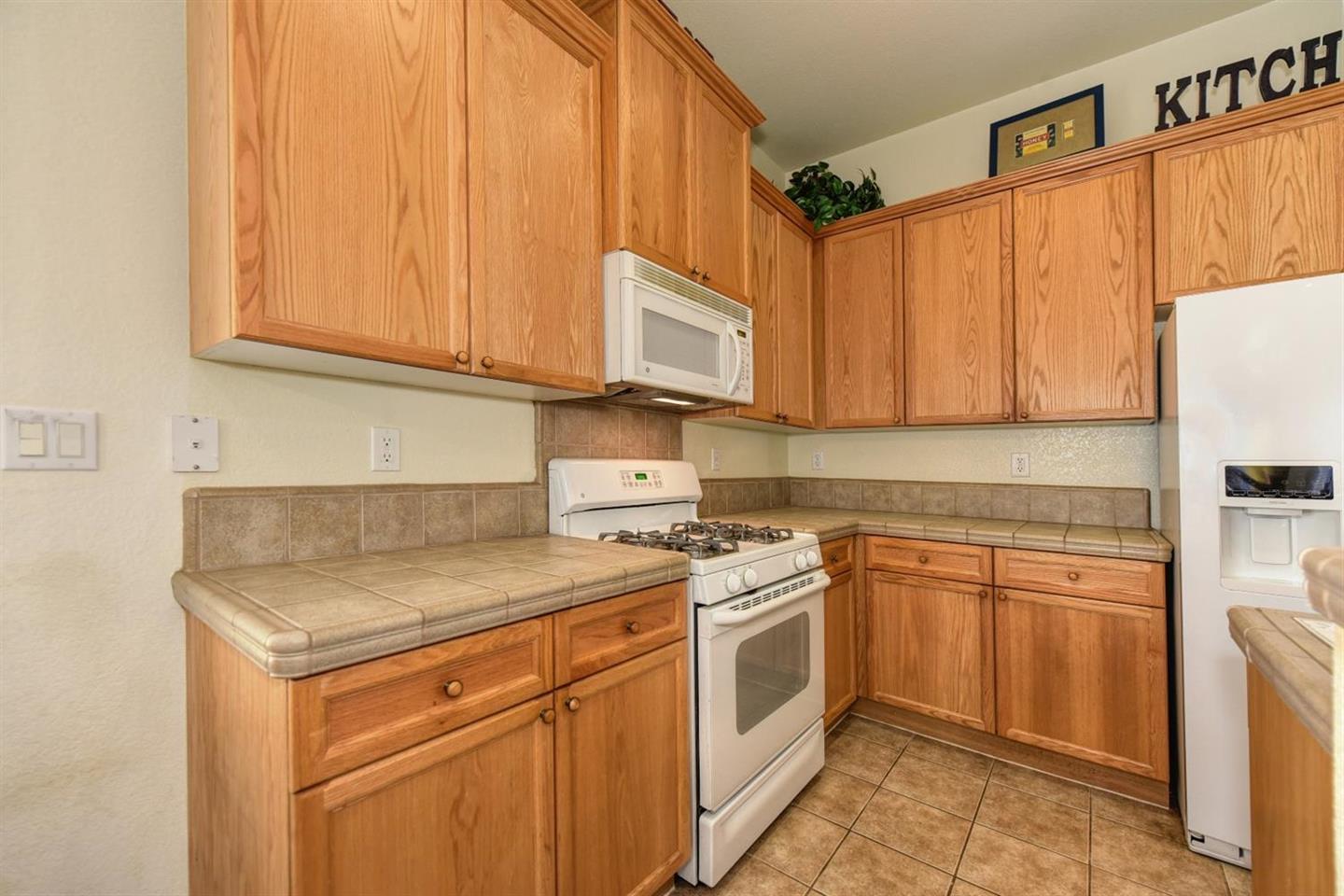 3557 Rainsong Circle Rancho Cordova, CA 95670 - Photo 13 of 27 a kitchen with stainless steel appliances granite countertop a sink a stove and cabinets