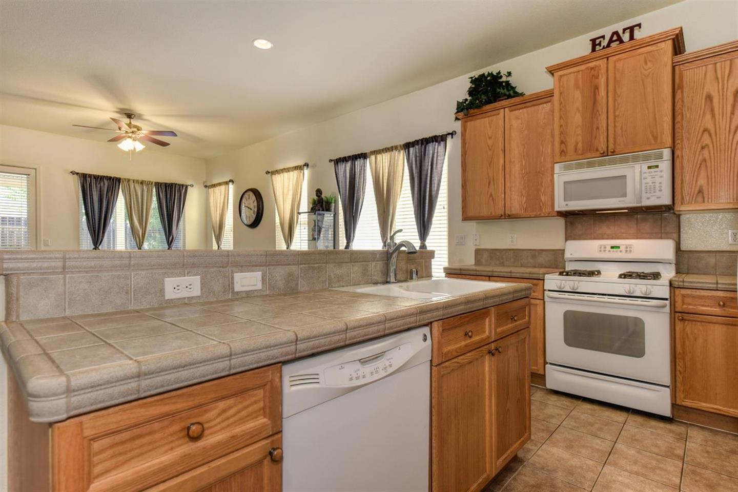 3557 Rainsong Circle Rancho Cordova, CA 95670 - Photo 14 of 27 a kitchen with a sink stove and microwave