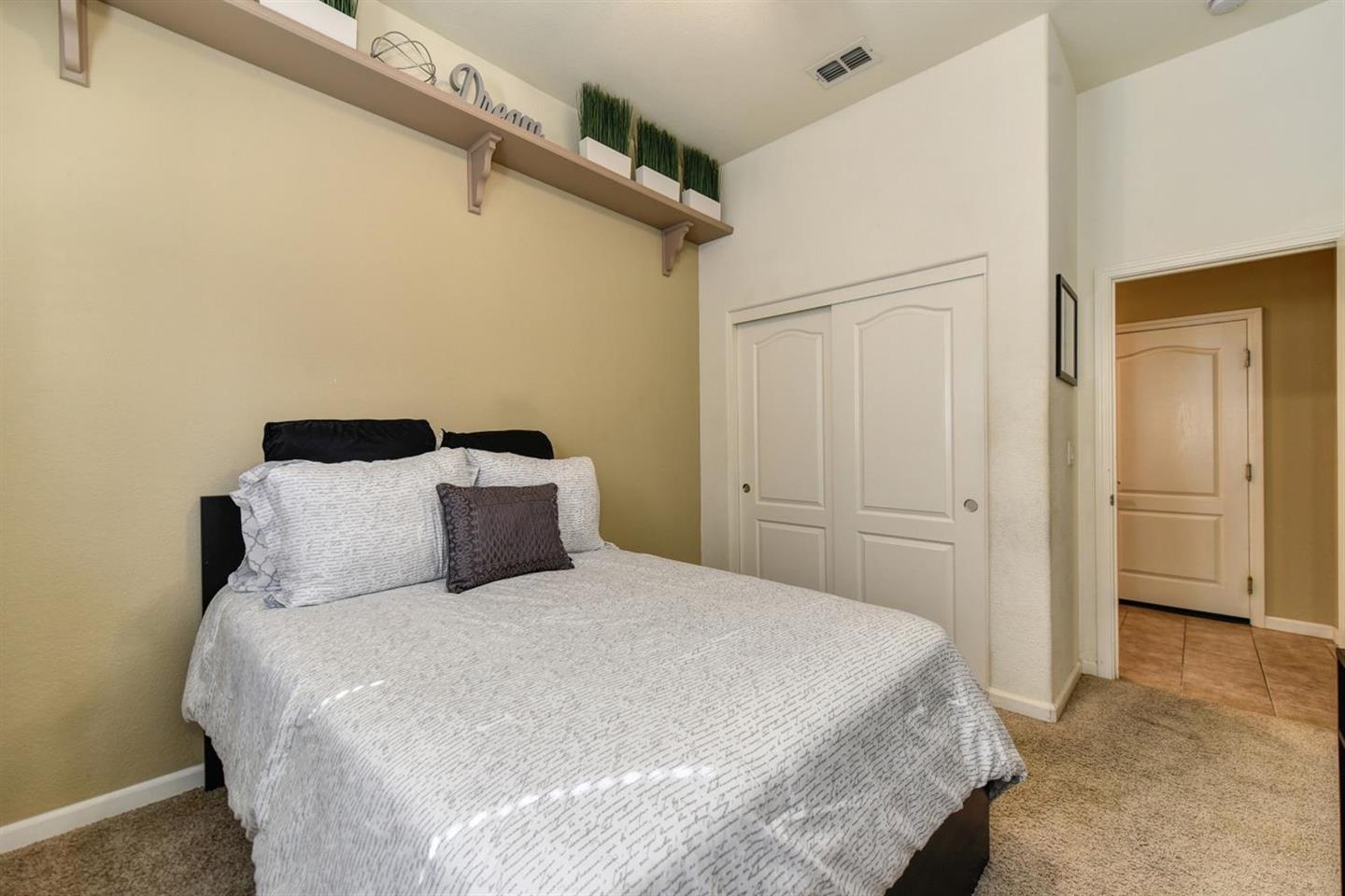 3557 Rainsong Circle Rancho Cordova, CA 95670 - Photo 16 of 27 a bedroom with a bed and a cabinet