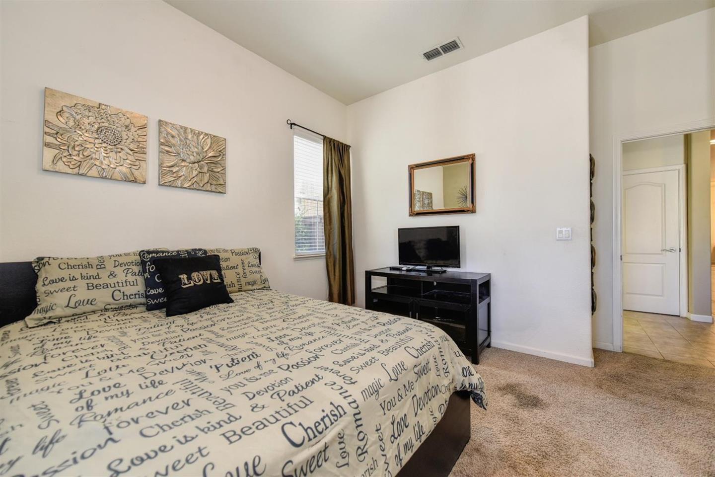 3557 Rainsong Circle Rancho Cordova, CA 95670 - Photo 20 of 27 a bedroom with a bed and a television