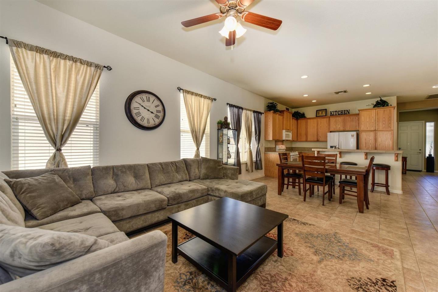 3557 Rainsong Circle Rancho Cordova, CA 95670 - Photo 2 of 27 a living room with furniture a clock and a window