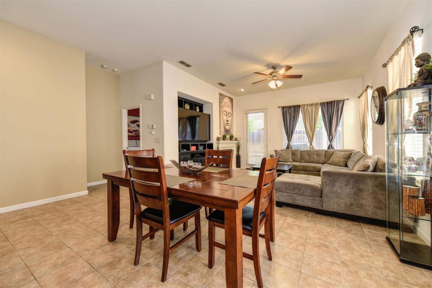 3557 Rainsong Circle Rancho Cordova, CA 95670 - Photo 7 of 27 a living room with furniture a chandelier and a window