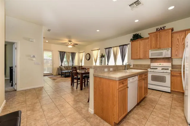 a kitchen with stainless steel appliances granite countertop a stove and a refrigerator