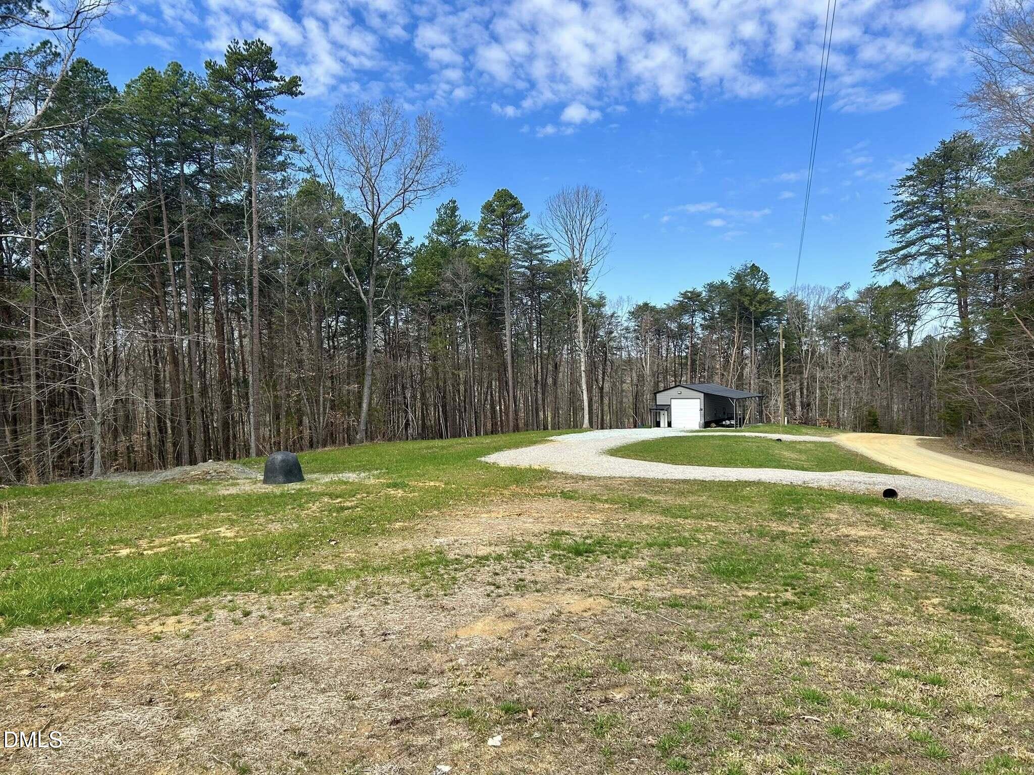 61 Ridgeview Road Leasburg, NC 27291 - Photo 2 of 10 a view of a backyard with a large tree