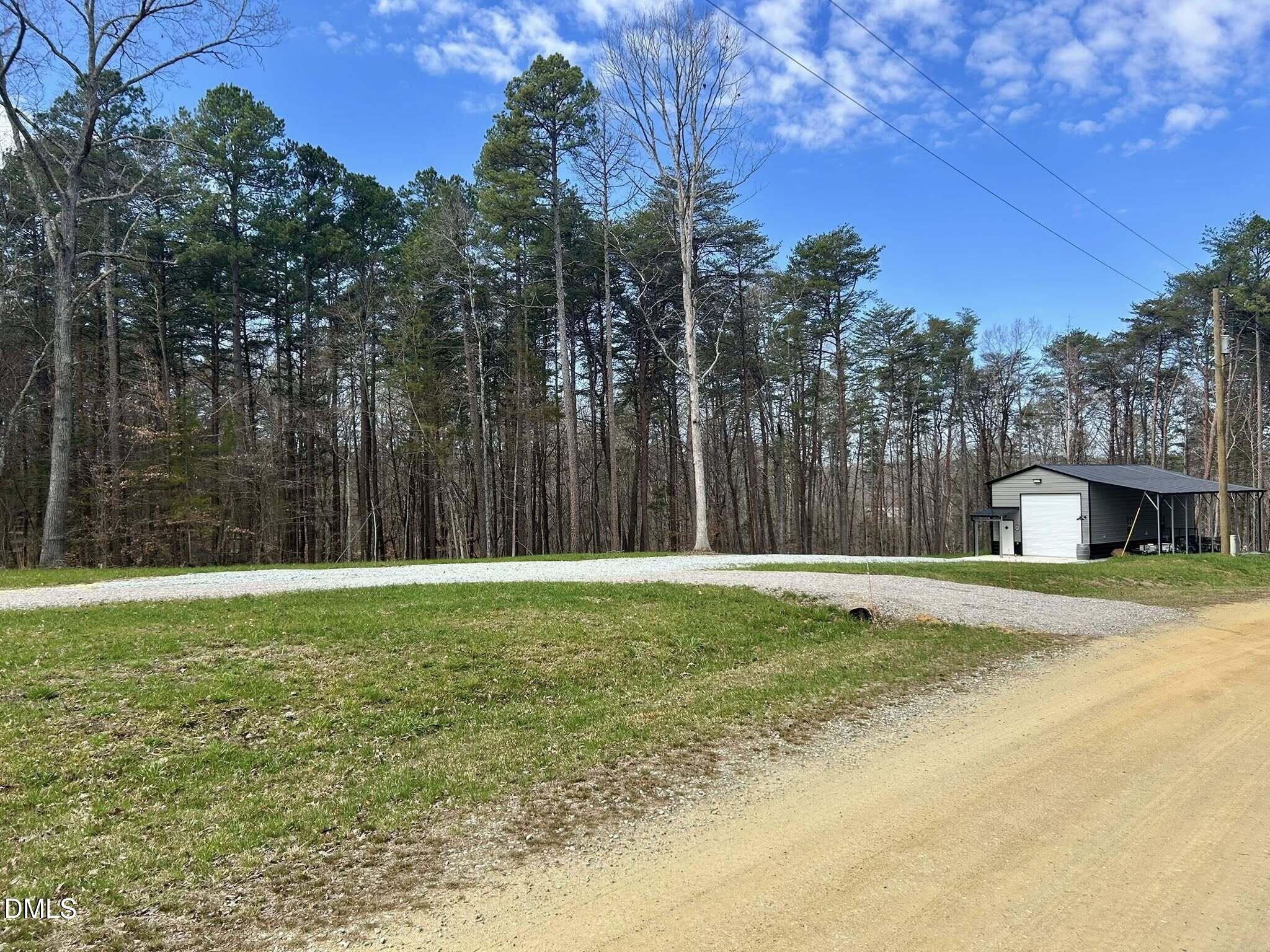 61 Ridgeview Road Leasburg, NC 27291 - Photo 3 of 10 a row of trees with wooden fence