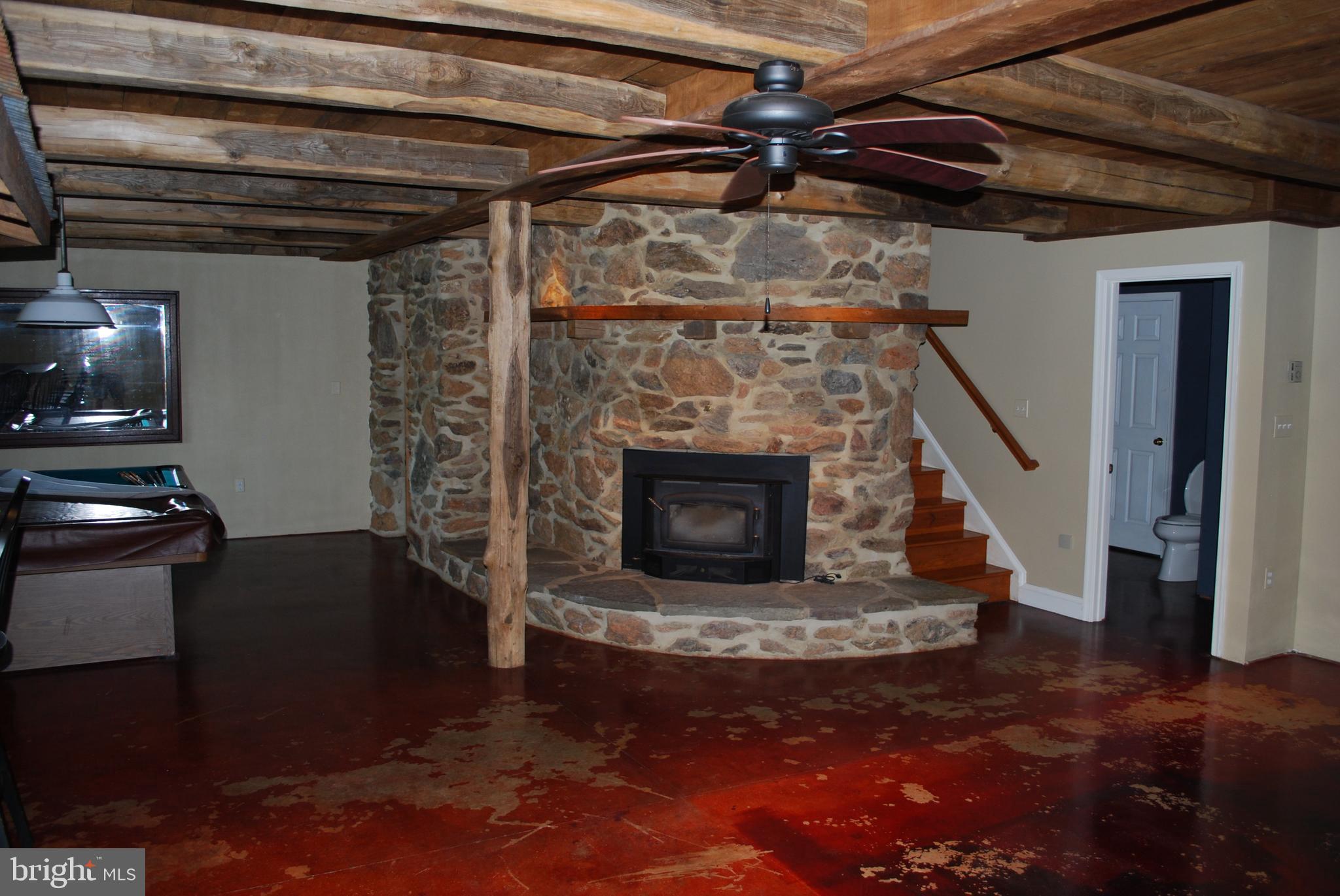 3901 Water Tank Road Manchester, MD 21102 - Photo 33 of 45 Basement game room with wood stove/fireplace