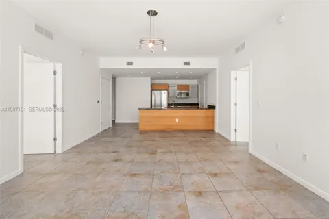 a view of a kitchen with a sink and a chandelier