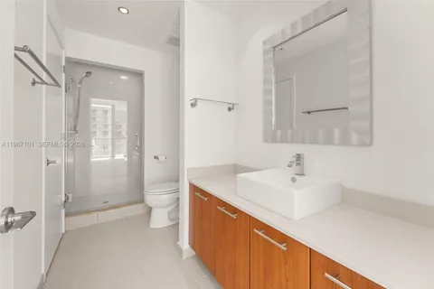 a spacious bathroom with a sink a toilet and shower