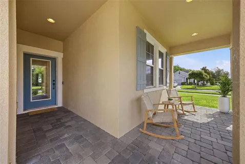 a view of a porch with a table and chairs