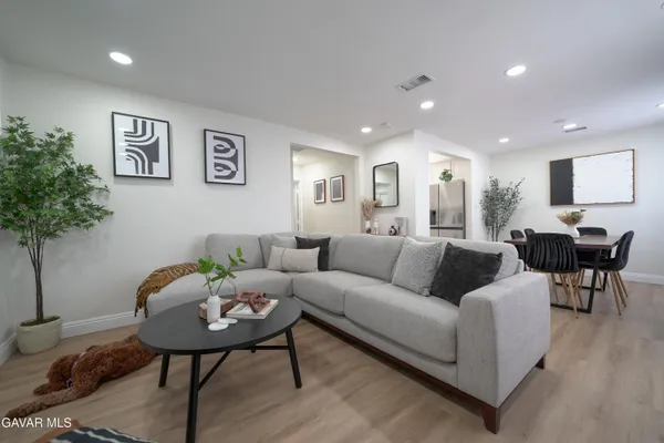 a living room with furniture and a potted plant