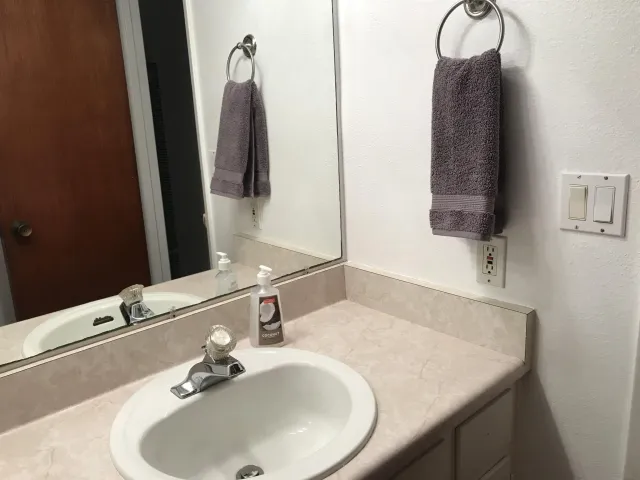 a bathroom with a sink and a mirror