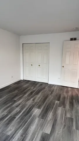 a view of wooden floor and cabinet in a room