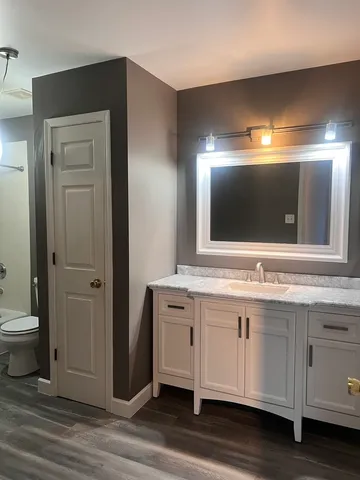 a bathroom with a double vanity sink and a mirror