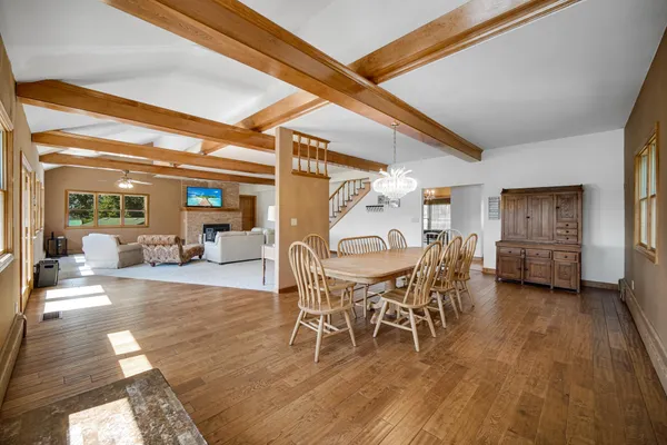 a dining room with furniture and wooden floor