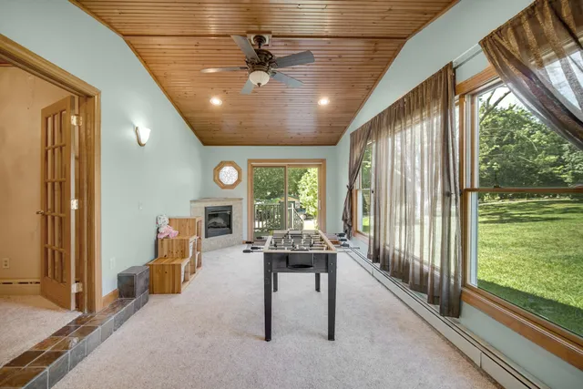 a livingroom with furniture water view and a floor to ceiling window