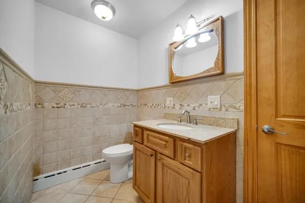 a bathroom with a sink a toilet and a mirror