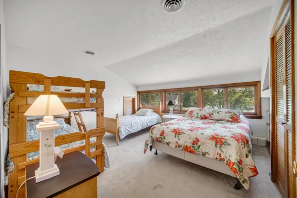 a bedroom with two beds and window