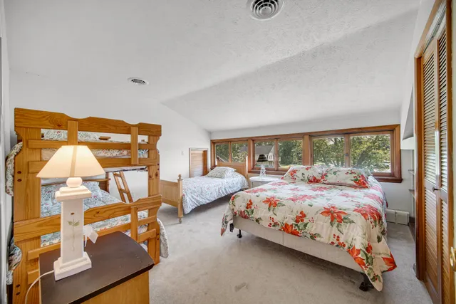 a bedroom with two beds and window