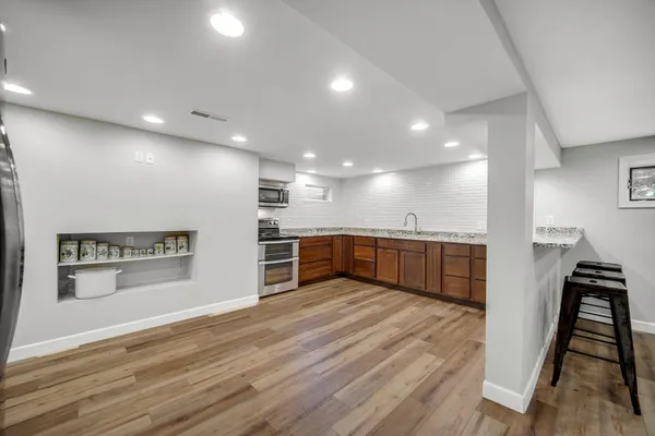 a view of a kitchen with a sink and a refrigerator