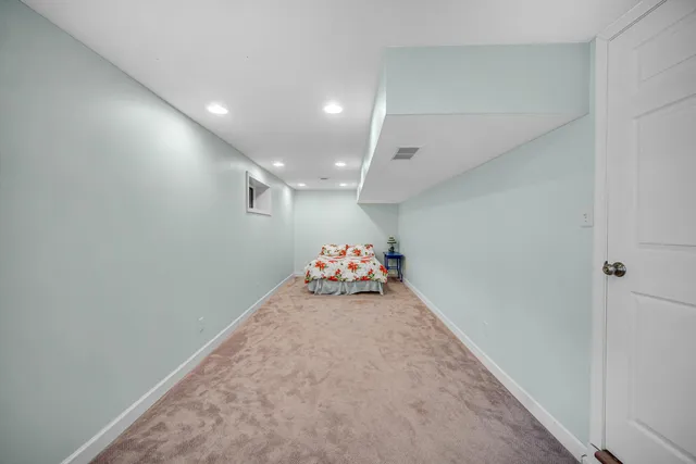 an empty room with furniture and a chandelier