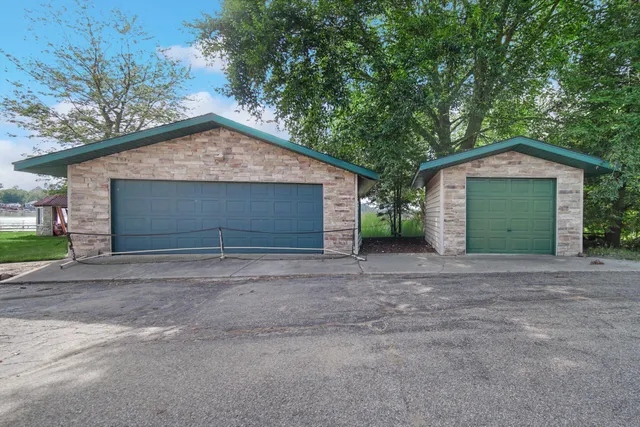 a view of a house with a yard and large tree
