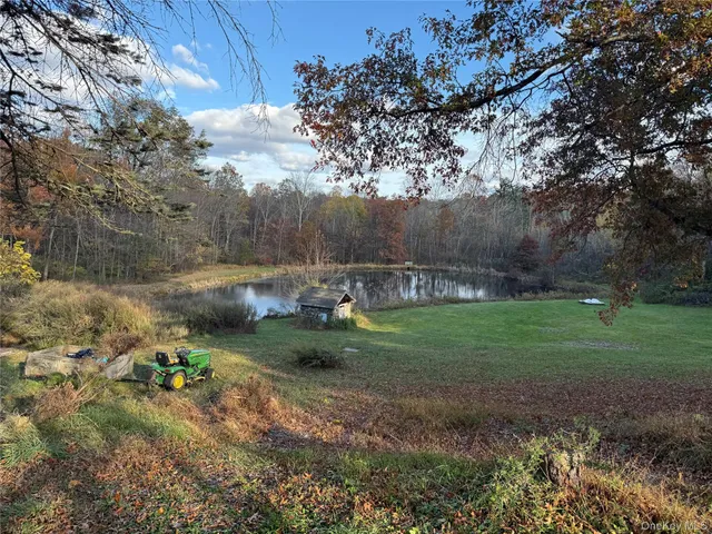 a red brick house with trees in front of it