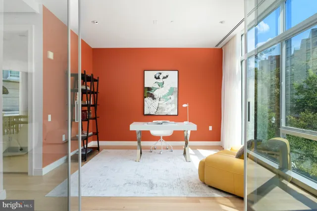 a living room with furniture a rug and a large window