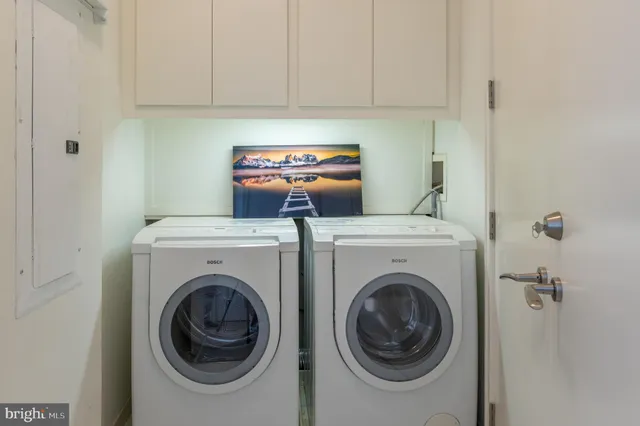 a view of a storage and utility room with washer and dryer