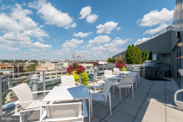 a view of a terrace with furniture and a stove