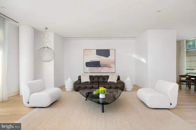 a living room with furniture and a lamp