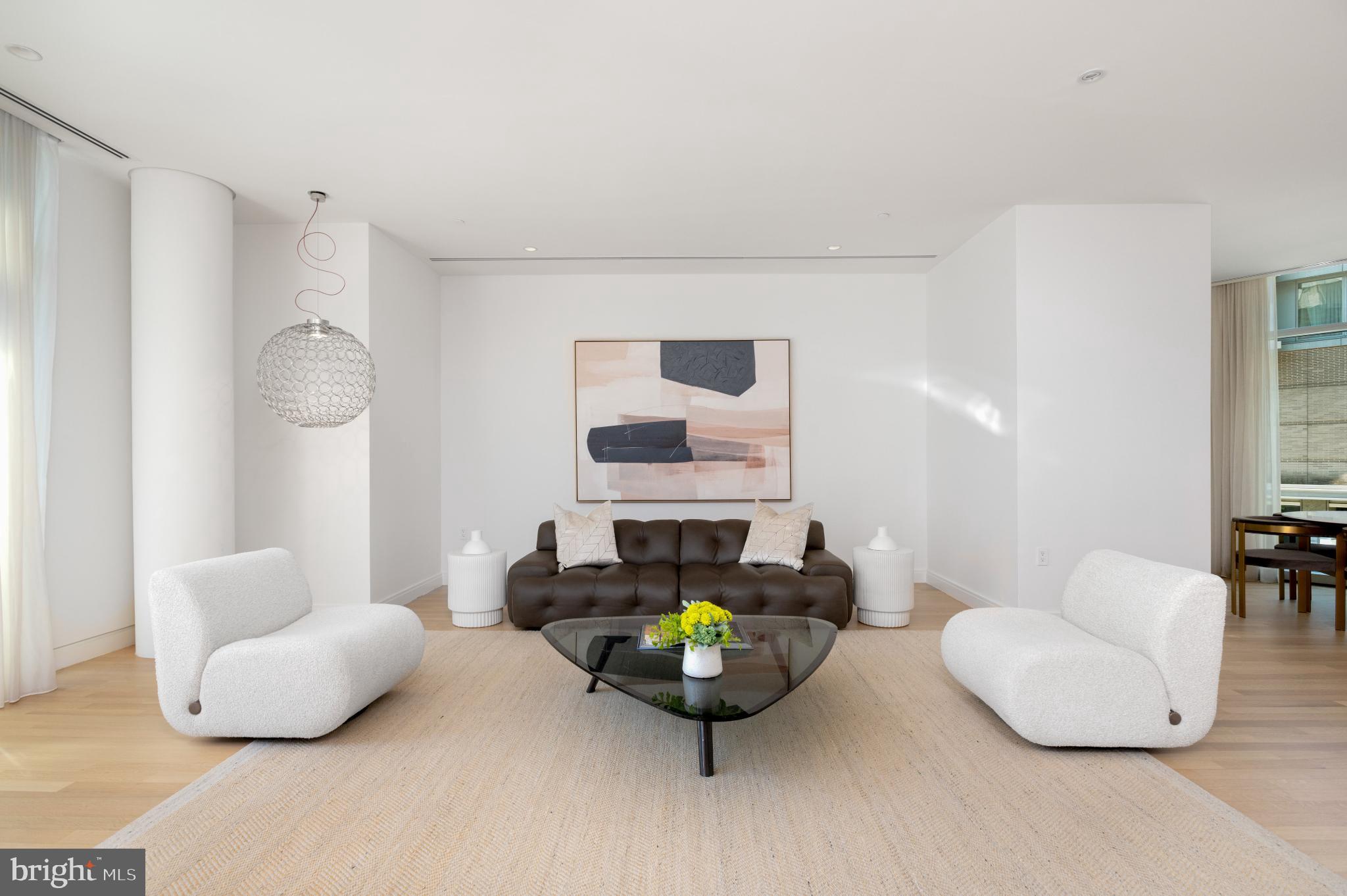 1177 22nd Street Northwest, Unit 2K Washington, DC 20037 - Photo 4 of 21 a living room with furniture and a lamp