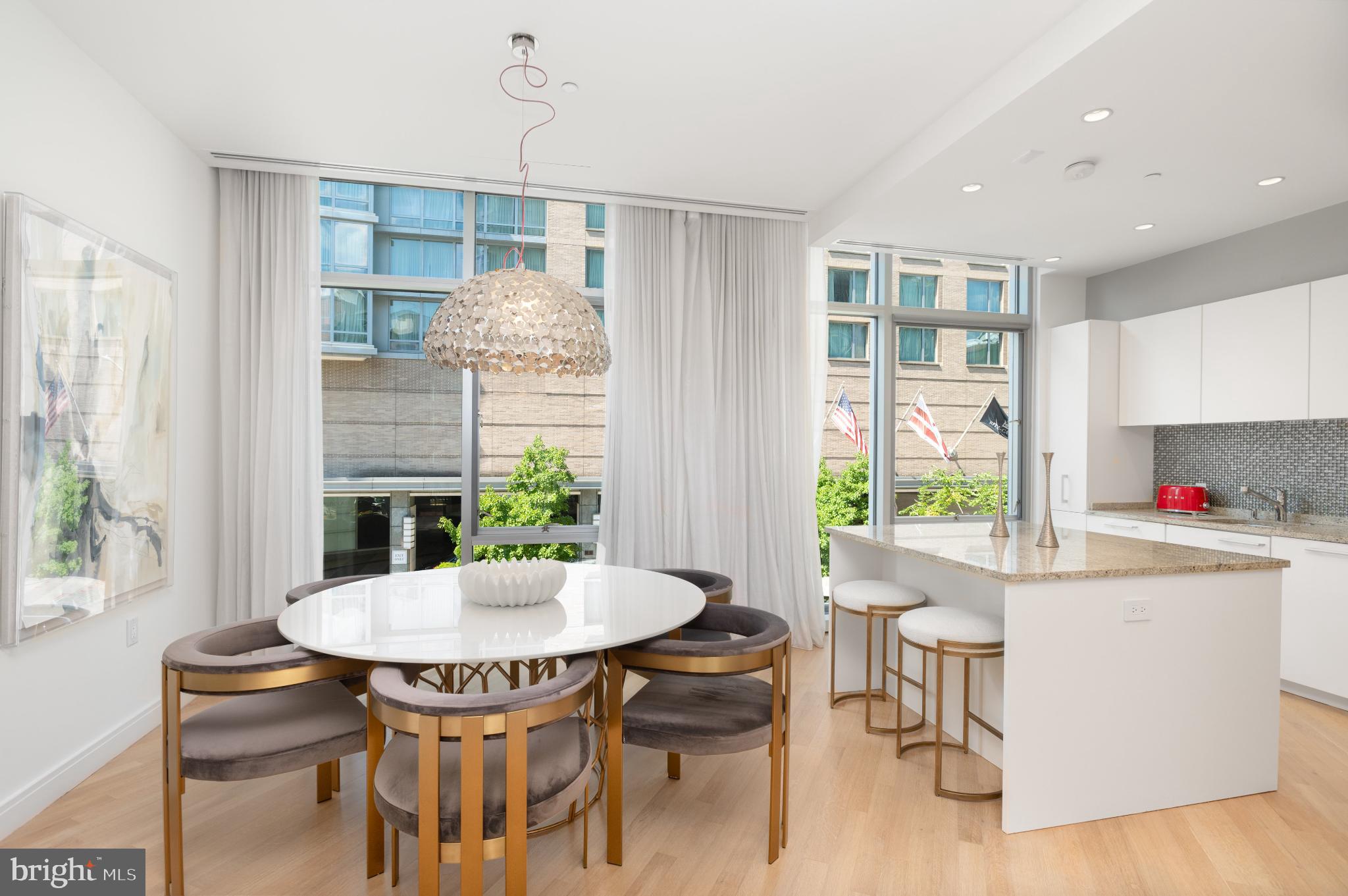 1177 22nd Street Northwest, Unit 2K Washington, DC 20037 - Photo 5 of 21 a view of a dining room with furniture window and outside view