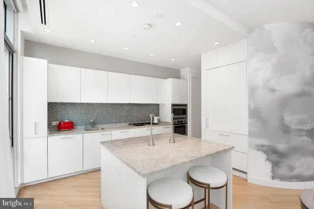 a kitchen with a sink a microwave and cabinets