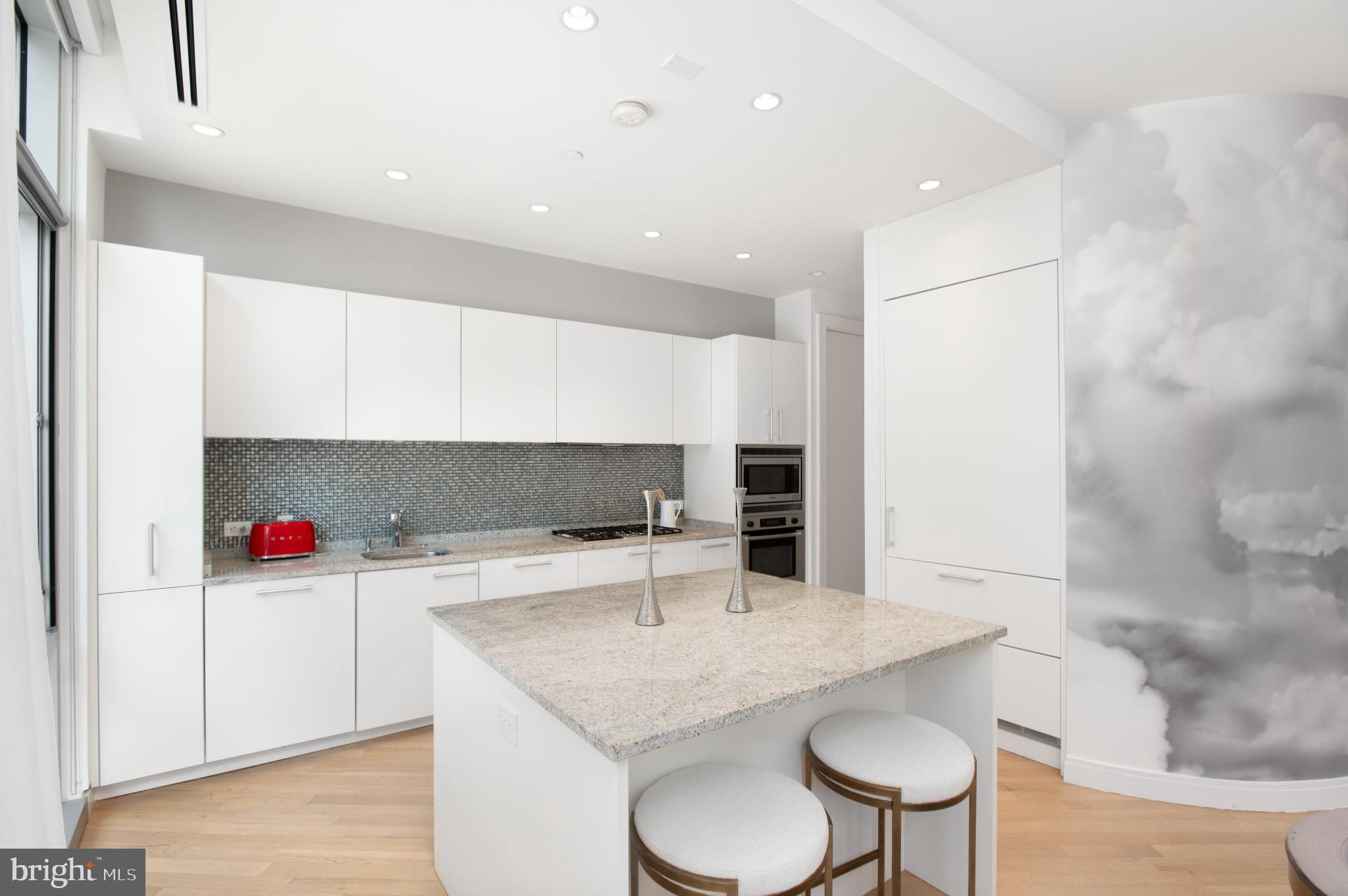 1177 22nd Street Northwest, Unit 2K Washington, DC 20037 - Photo 6 of 21 a kitchen with a sink a microwave and cabinets