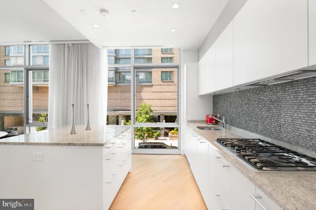 a kitchen with a stove a refrigerator and a window